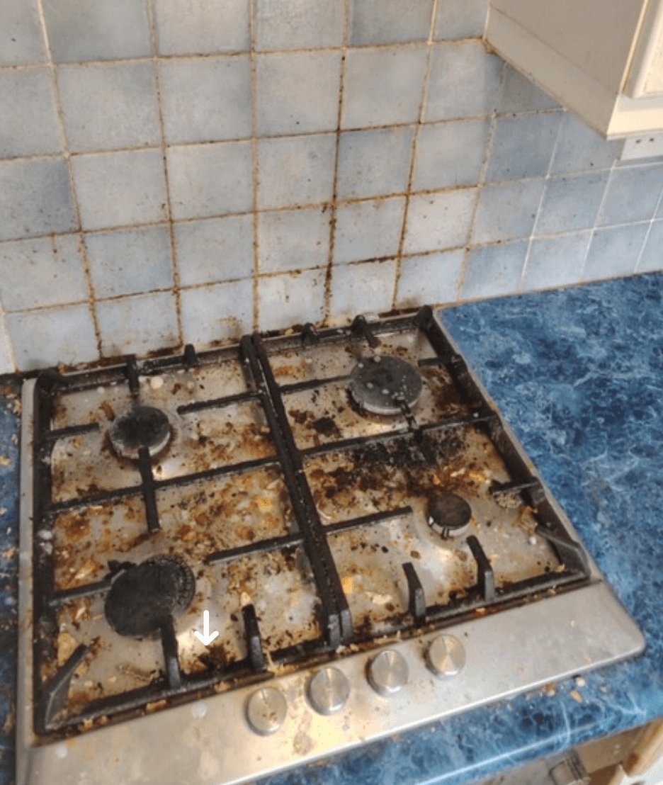 A cooker hob covered in grease and grime